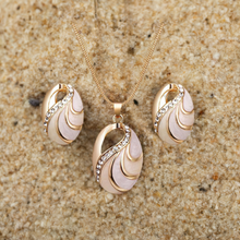 Load image into Gallery viewer, Jewelry set with pendant and earrings on a sandy background