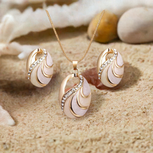 Load image into Gallery viewer, Jewelry set with necklace and earrings on a sandy background